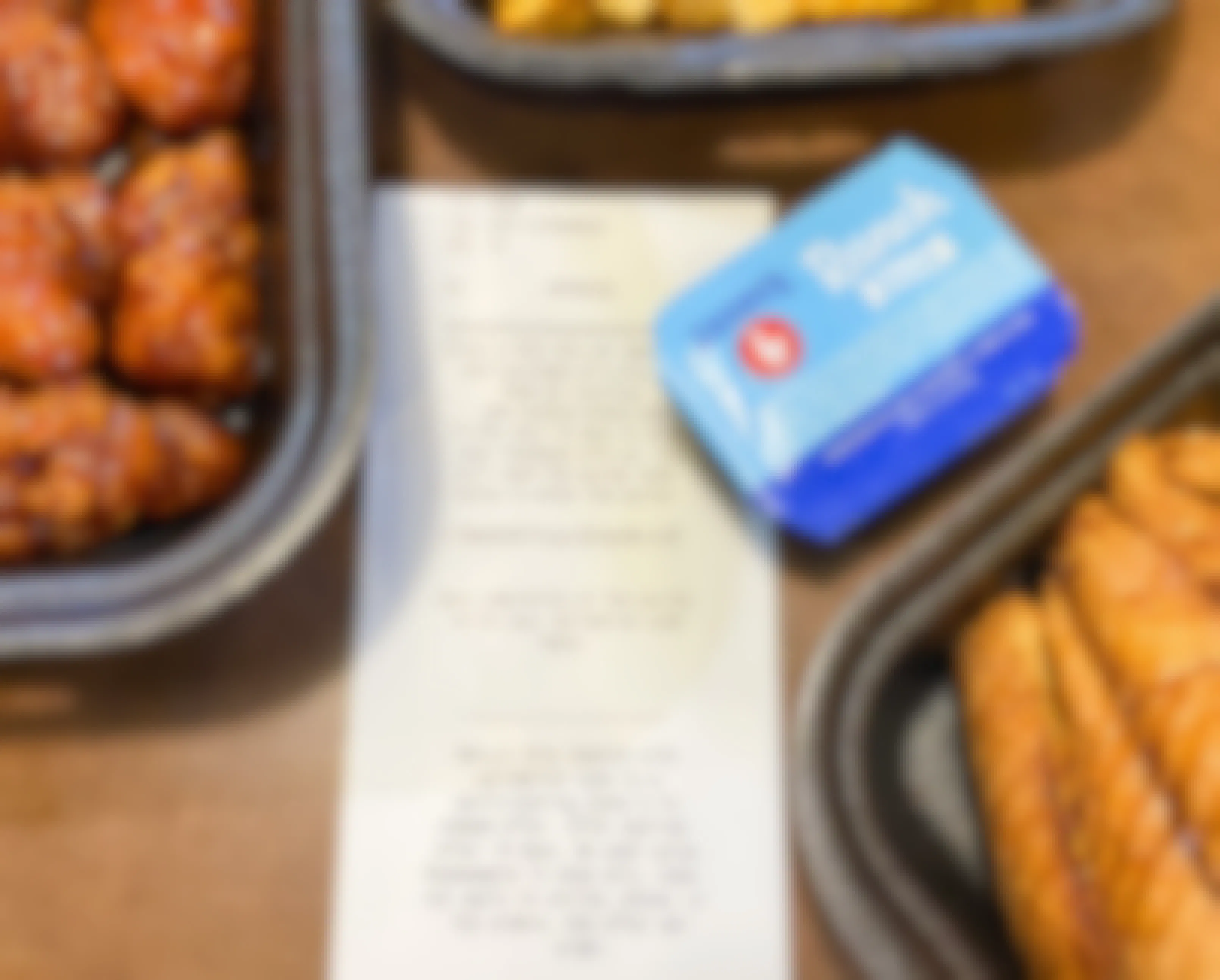 A Zaxby's receipt laying on a table next to boxes of chicken and a ranch container.