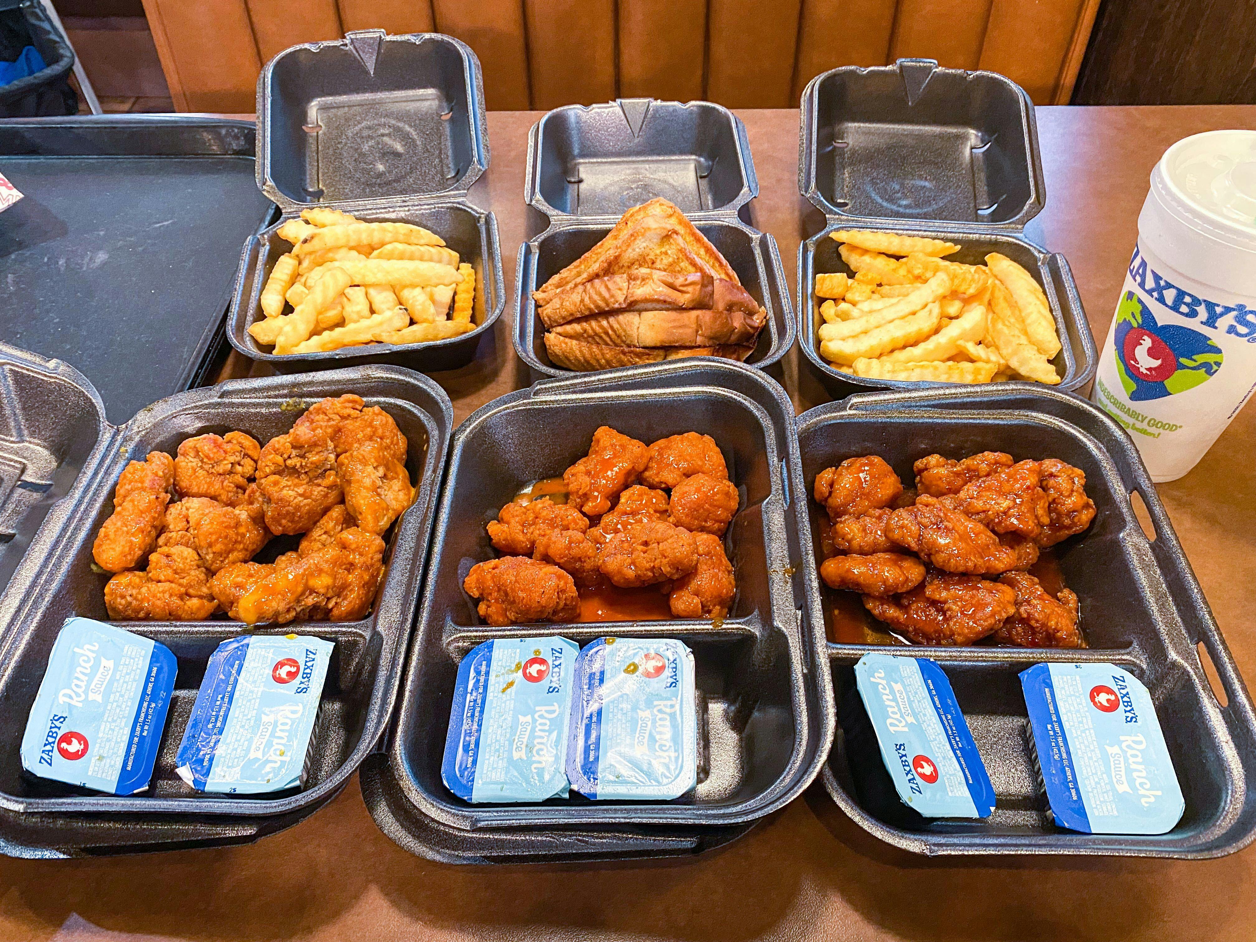 open takeout boxes of zaxby's BOGO boneless wings meals