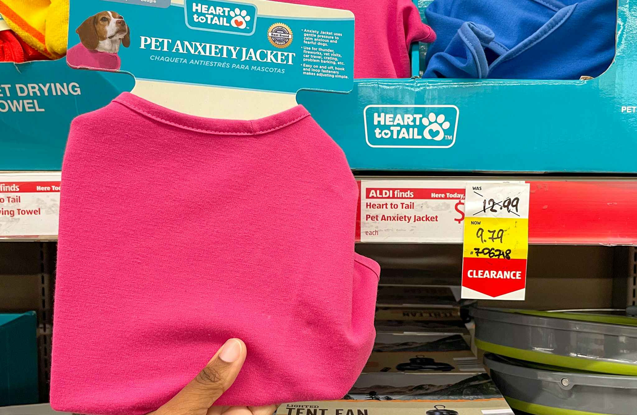 pet anxiety jacket held near sales sign at aldi