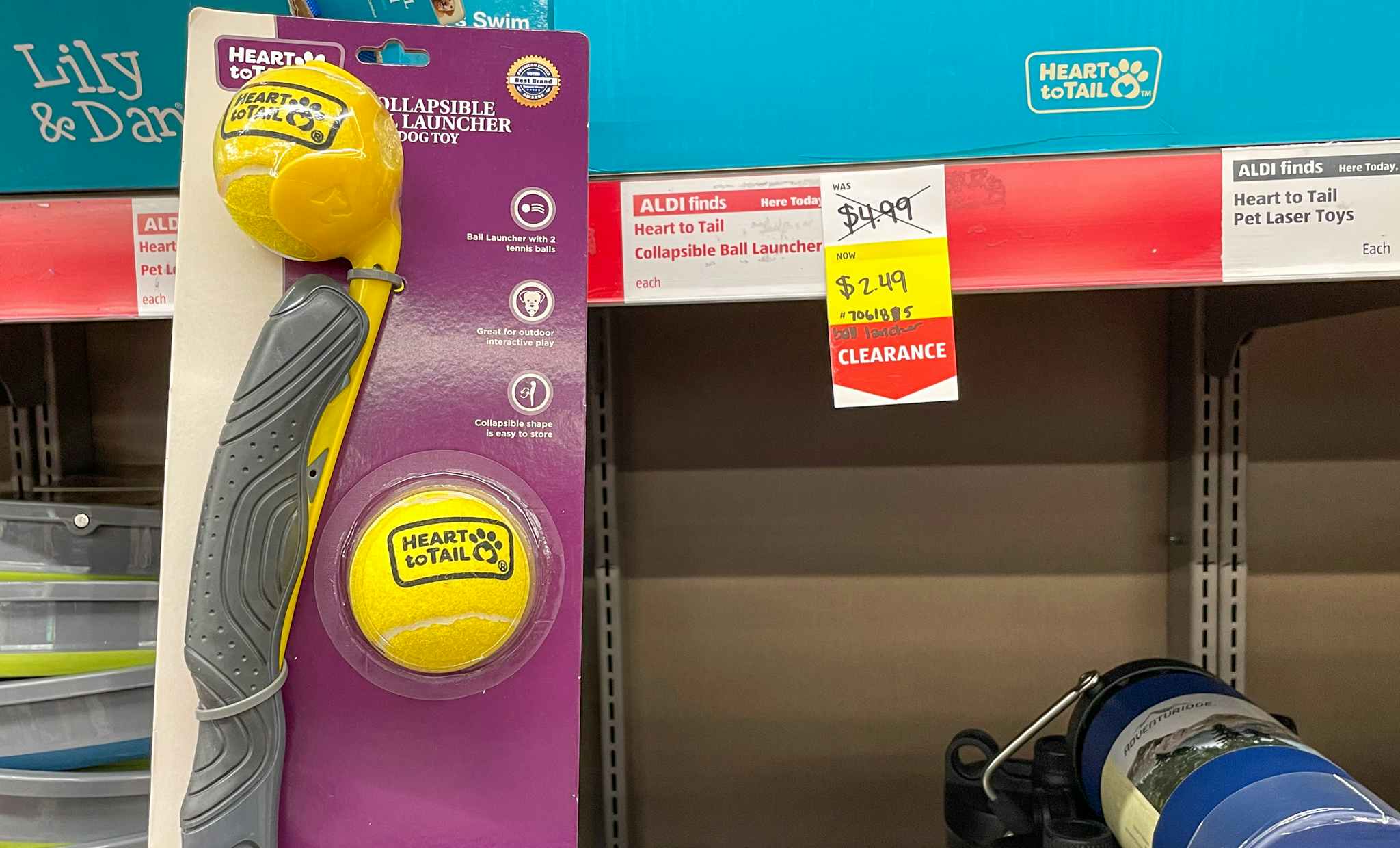 pet ball launcher held up near sales sign at aldi