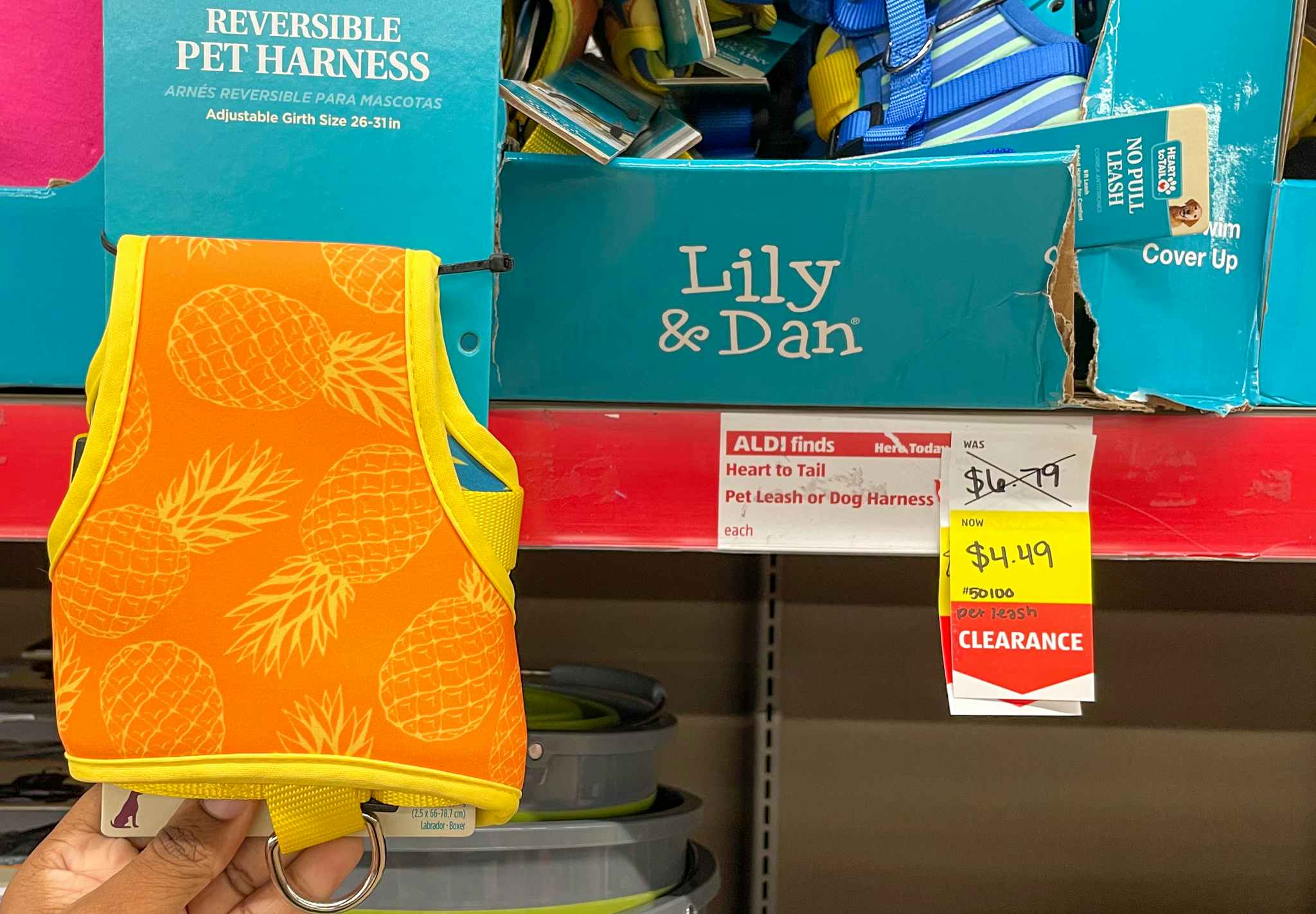 pet harness held near sales sign at aldi