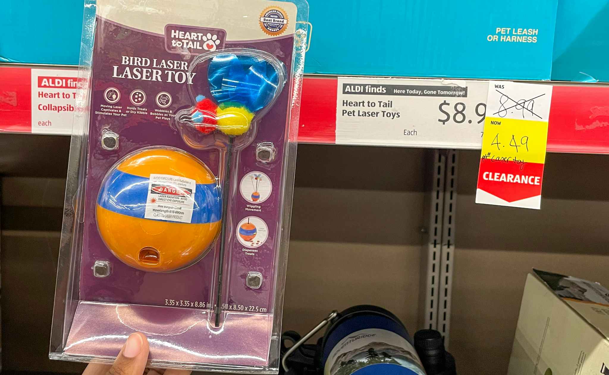 pet laser toy held up near sales sign at aldi