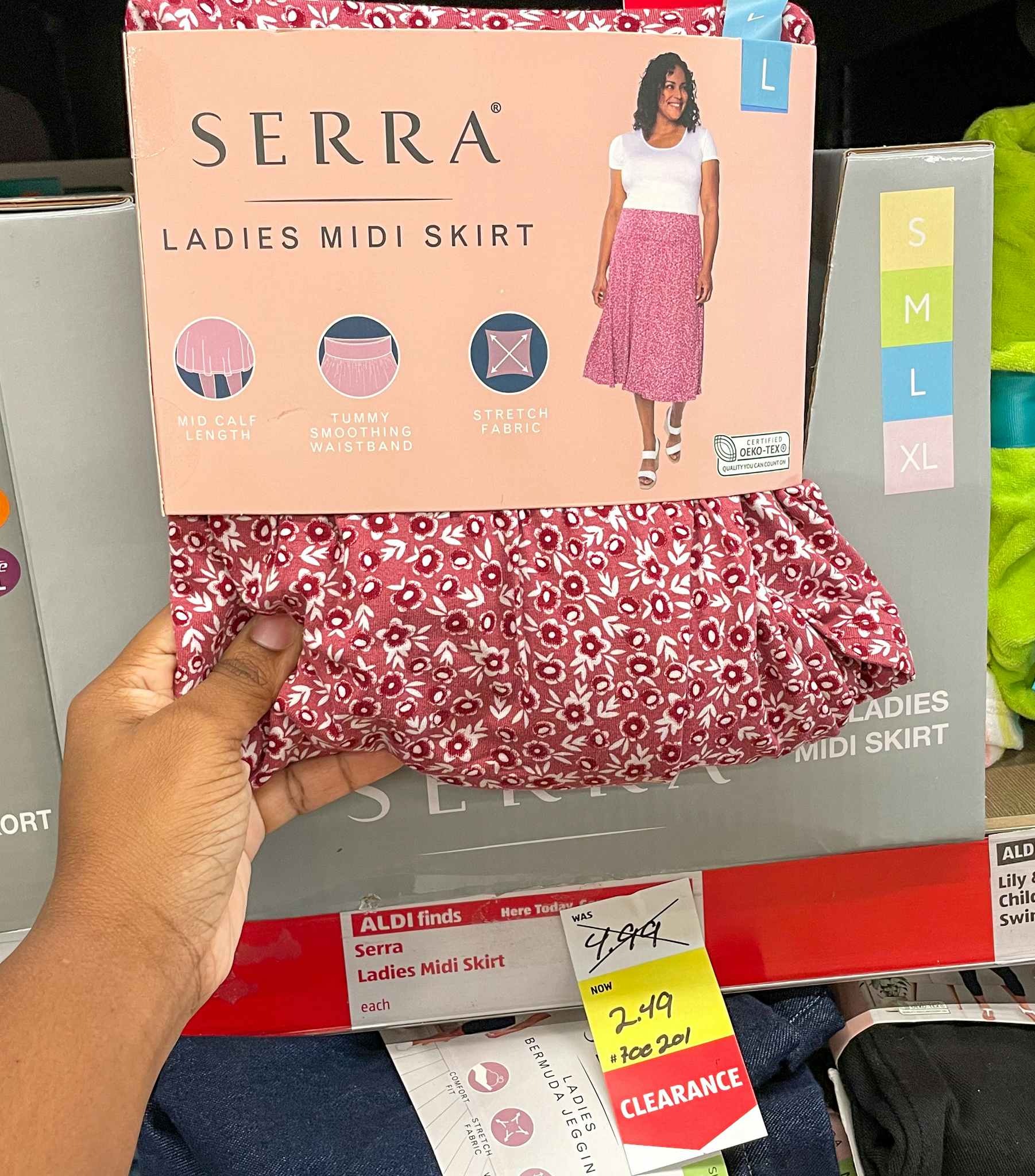 midi skirt in package held up near sales tag at aldi