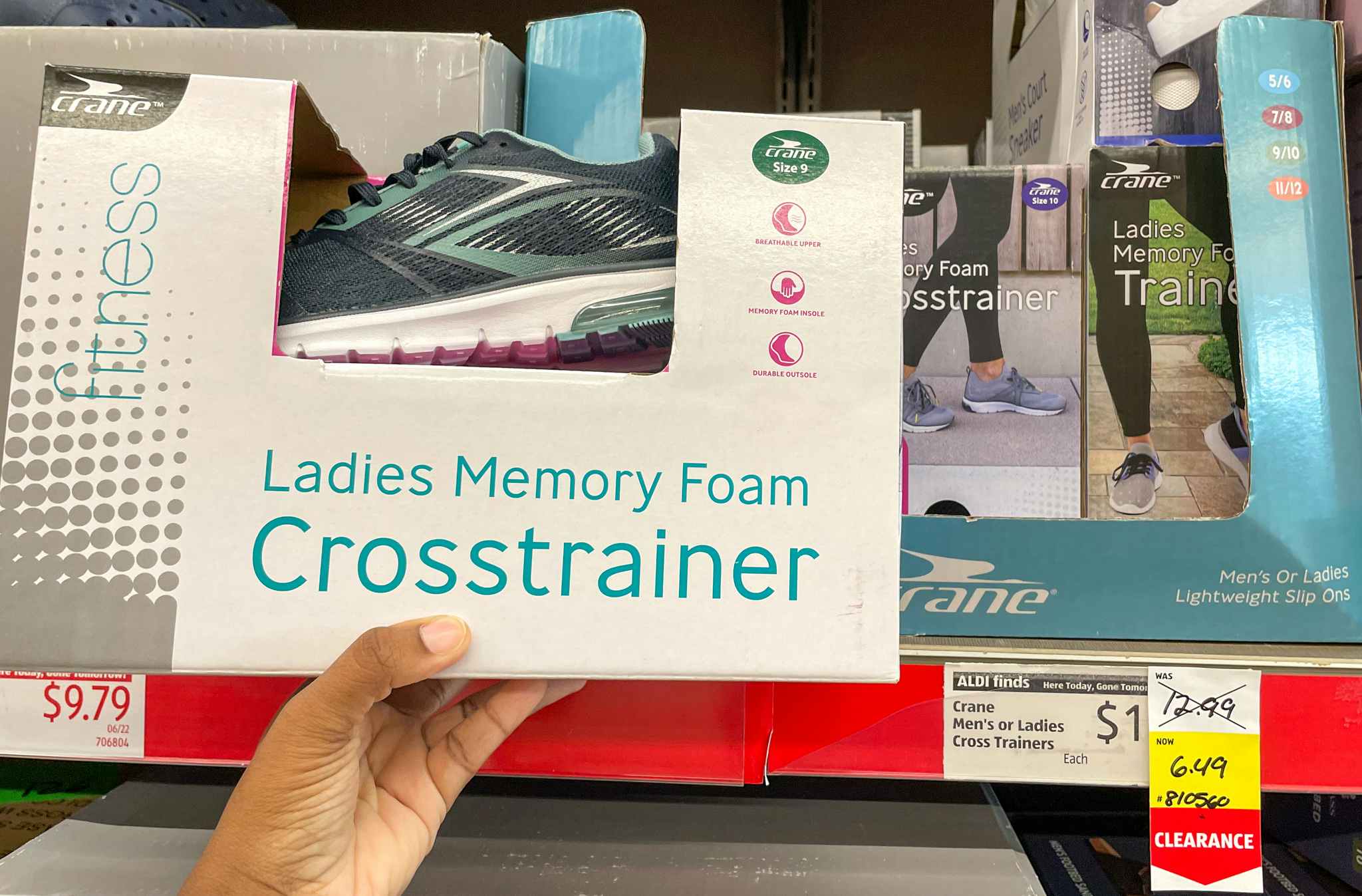 memory foam sneakers held by hand near sales tag at aldi 