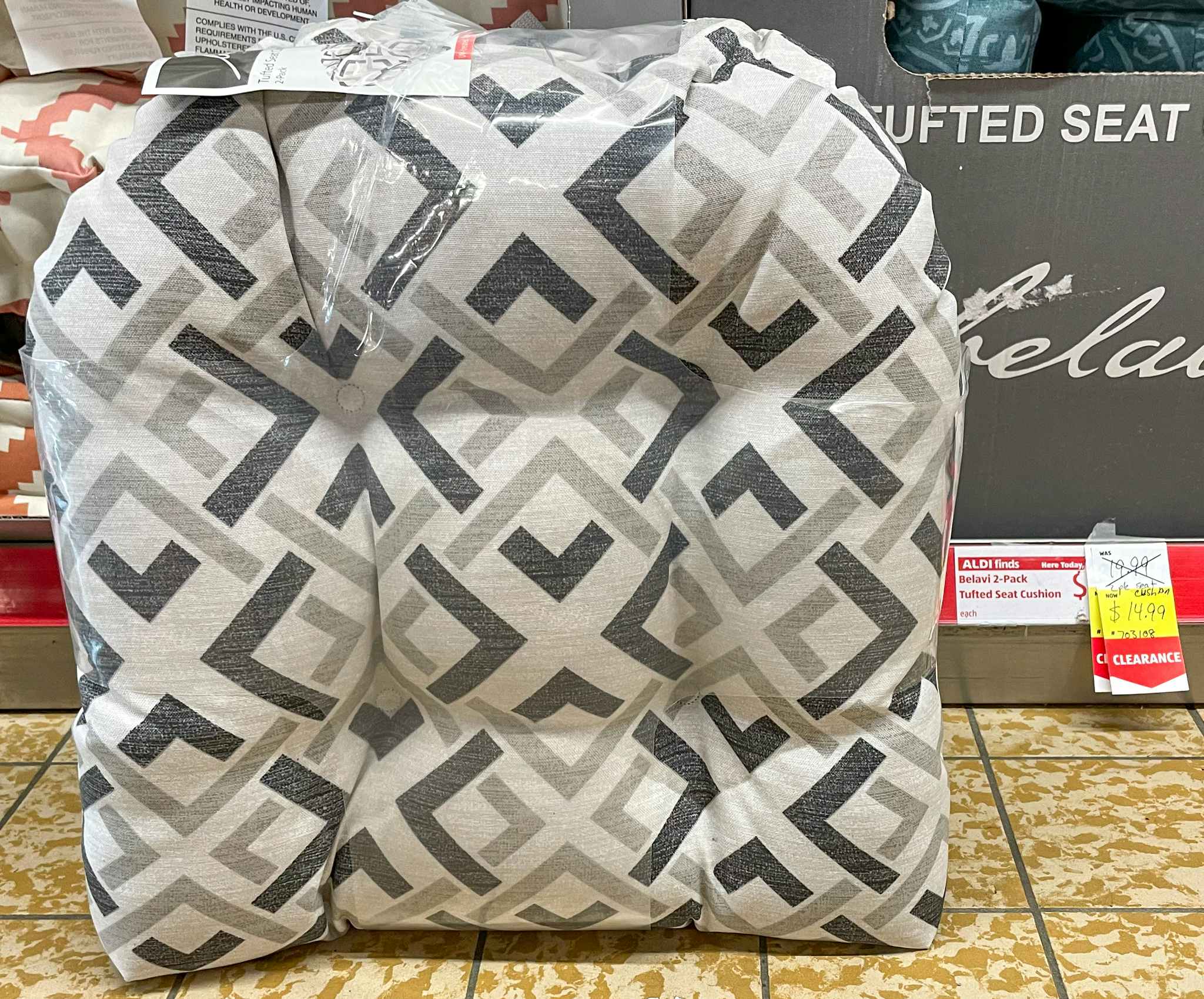 seat cushions on the floor aisle near a sales tag at aldi