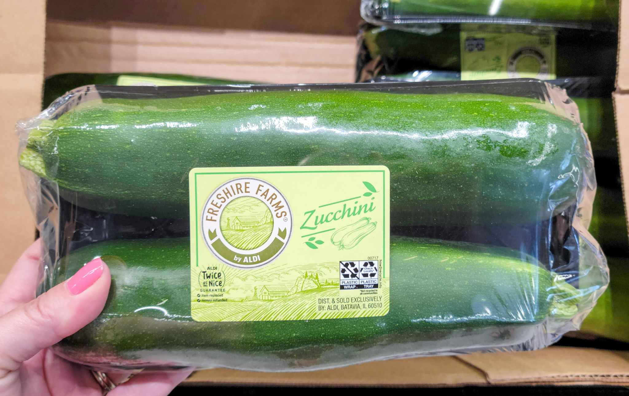 hand held zucchini in package at aldi