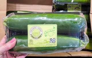 hand held zucchini in package at aldi