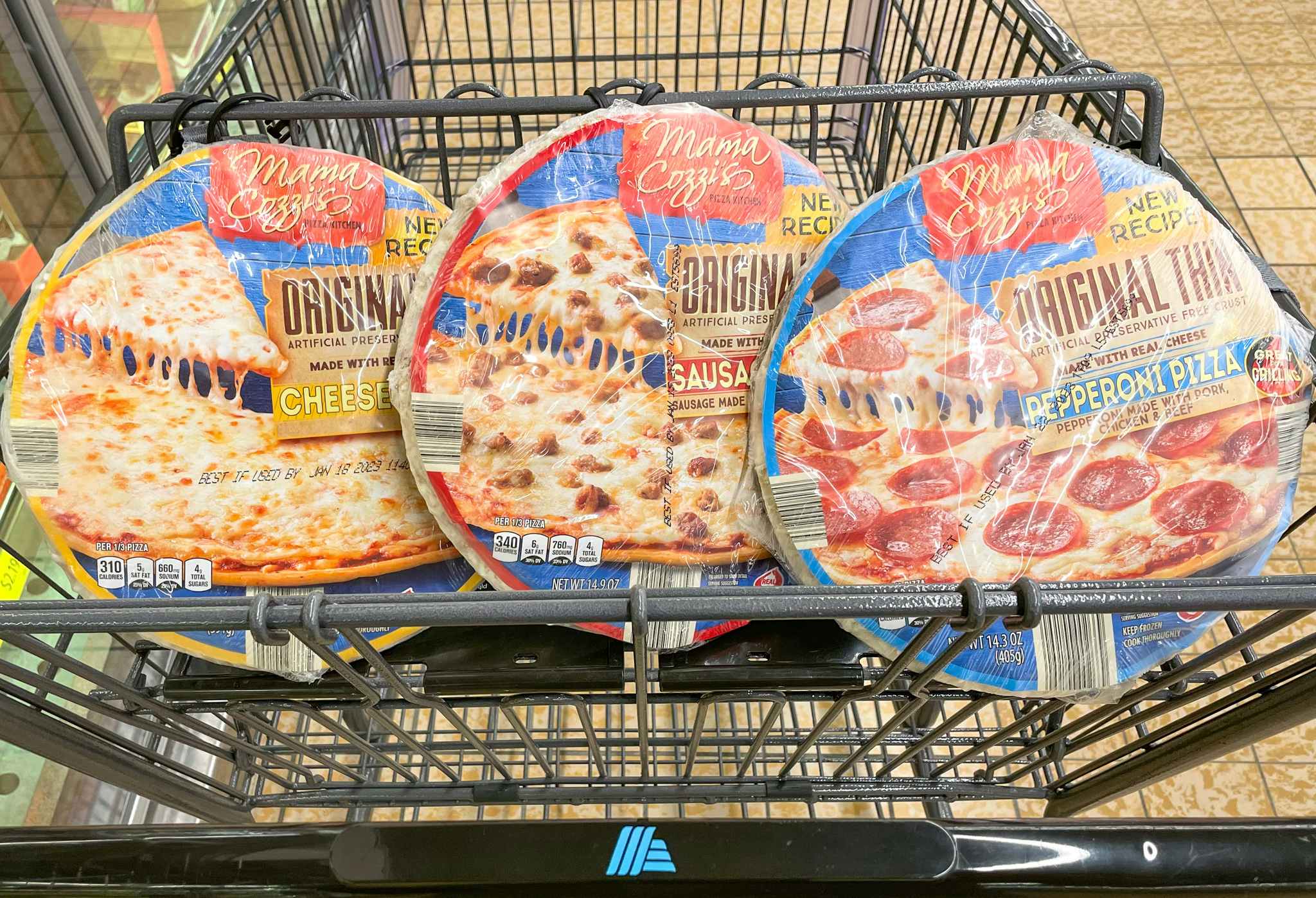 three thin crust pizzas in a cart at aldi 
