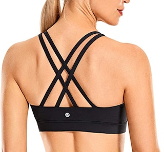 A model wearing a black strappy sports bra