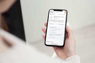 Woman accessing Amazon Clinc interface on her smartphone, looking at treatment for allergies