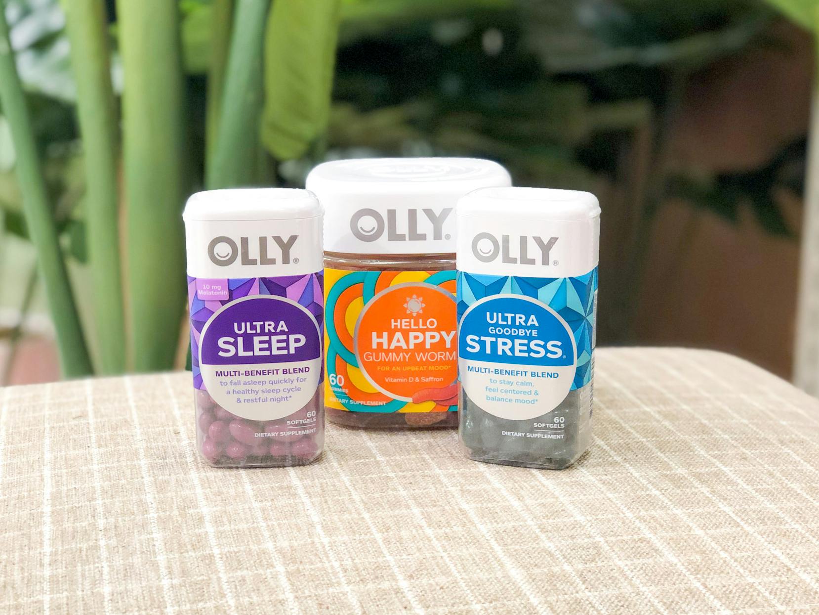 varieties of olly vitamins posed in front of greenery