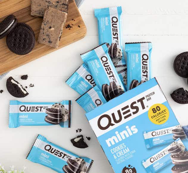 box of quest cookies and cream protein bar minis spilling onto table