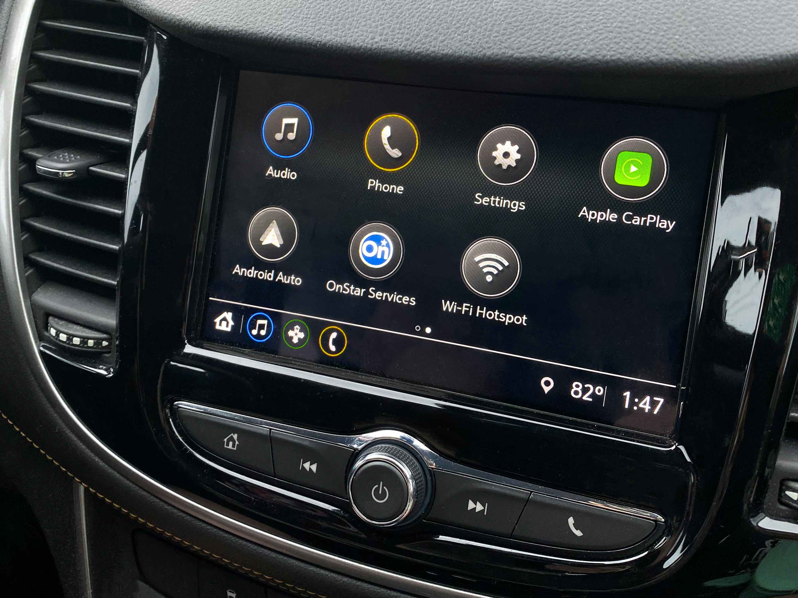 A close-up on a dashboard screen with Apple Car Play highlighted to activate.