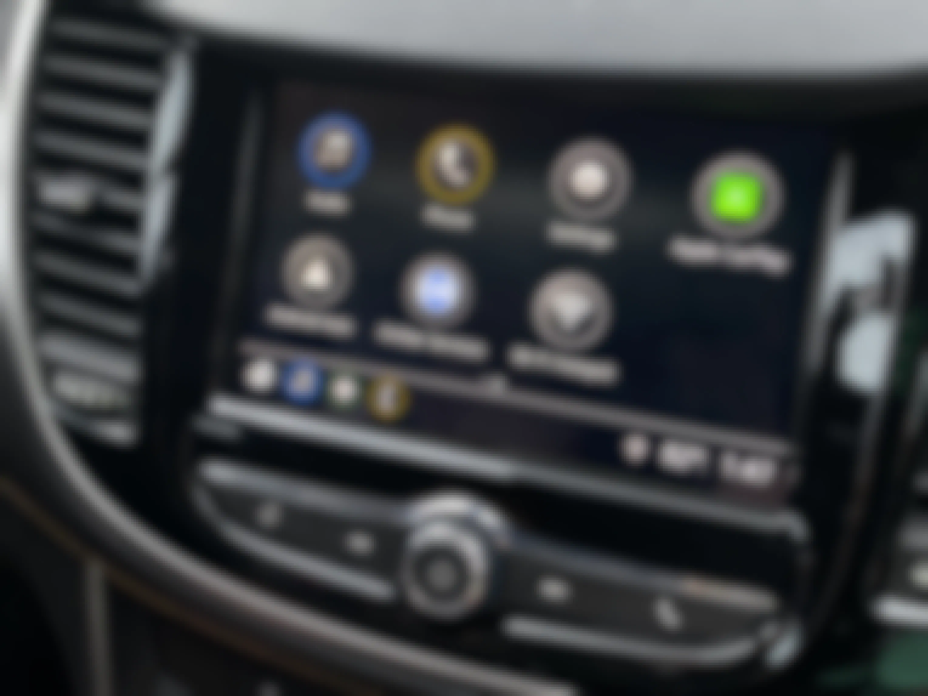 A close-up on a dashboard screen with Apple Car Play highlighted to activate.