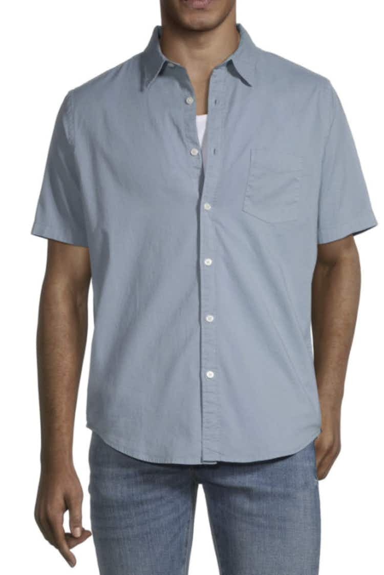 a man wearing a dusty blue button down short sleeve shirt