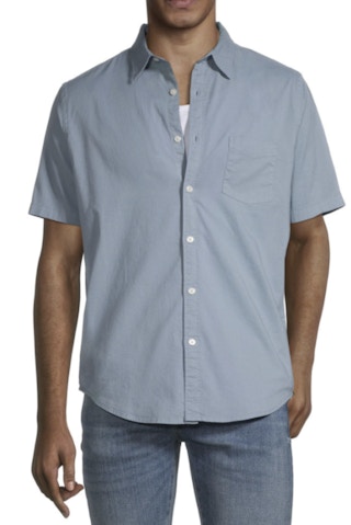 a man wearing a dusty blue button down short sleeve shirt