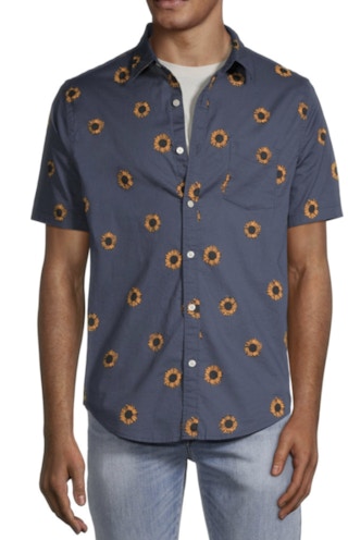a man wearing a blue button down short sleeve shirt with orange flowers