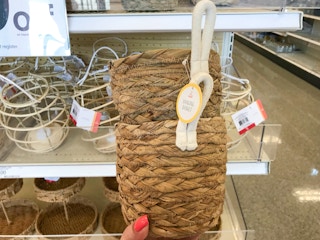 holding up two hanging baskets at Target