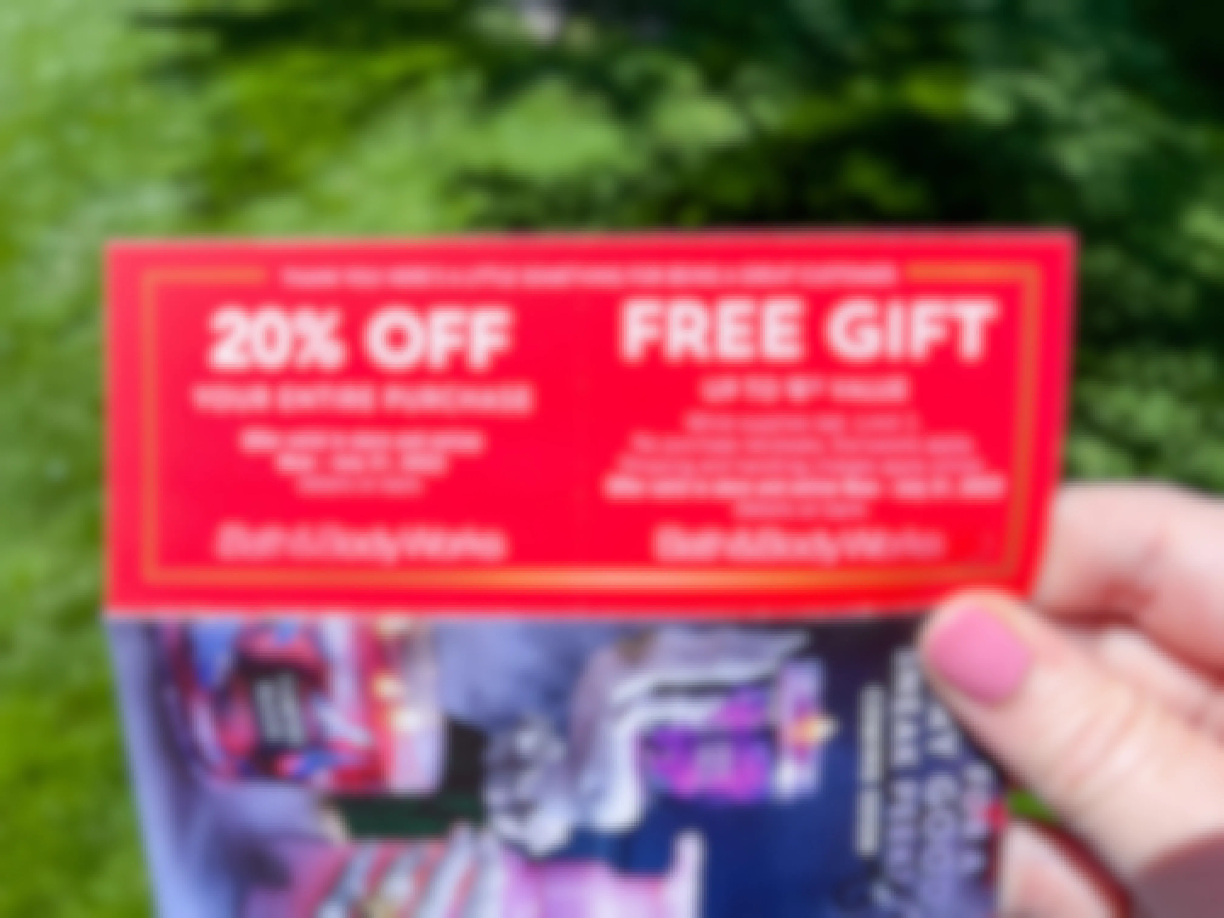 A close up of a bath and body works coupon in coupon book.