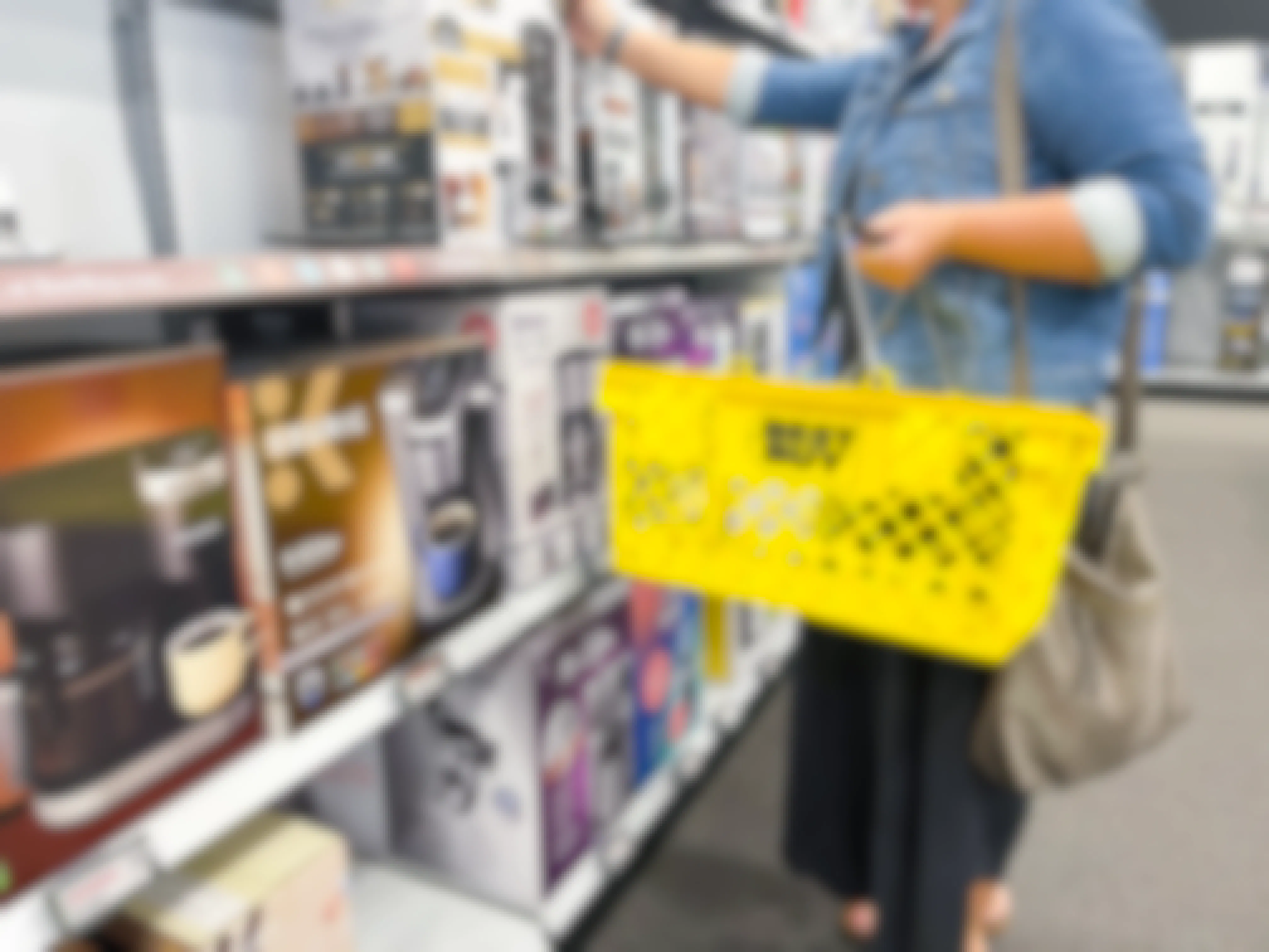 person shopping at best buy with yellow basket