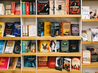 A wall of bookshelves filled with science fiction books.