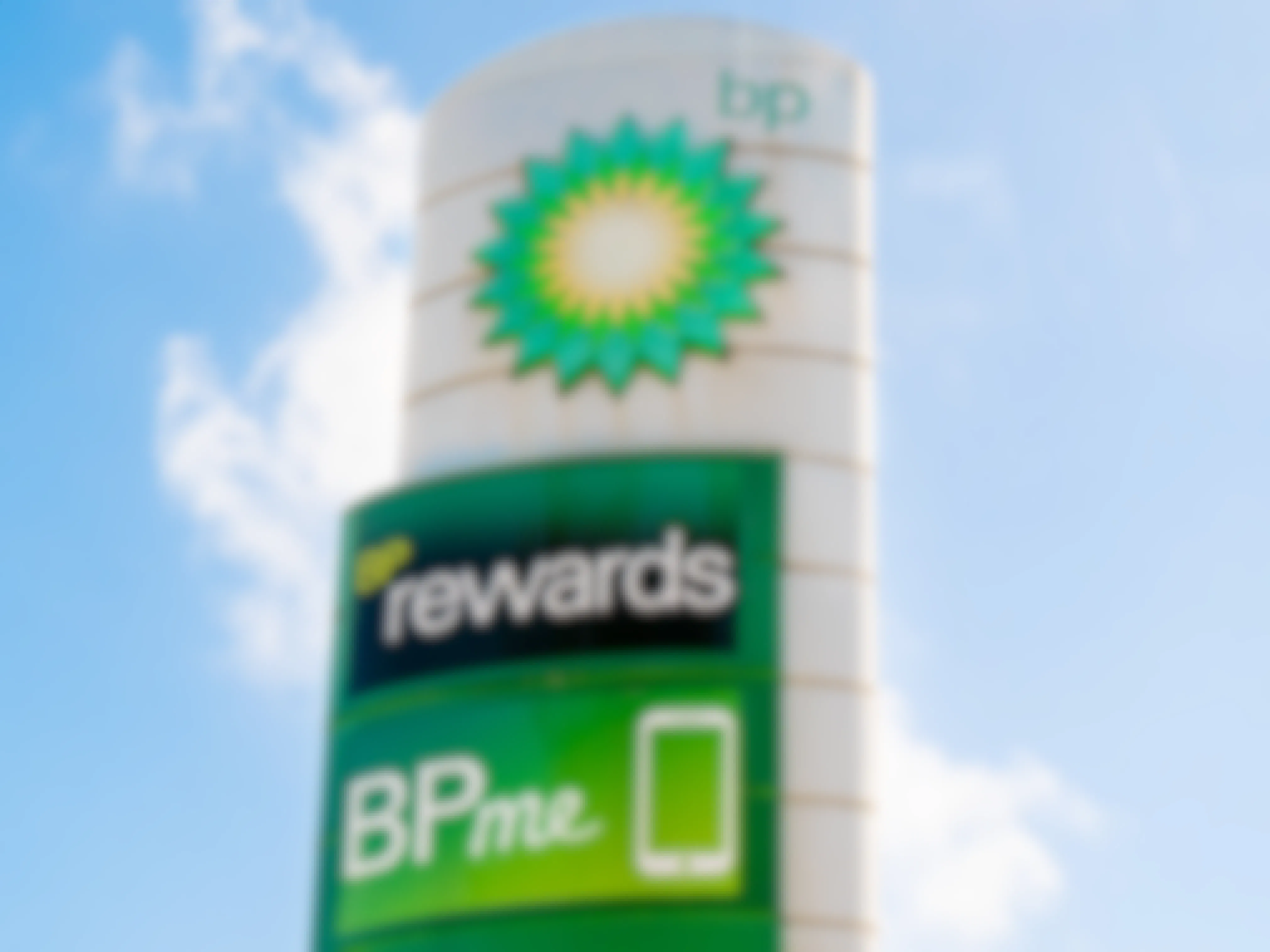 A sign next to a BP gas station advertising the BPme rewards app.