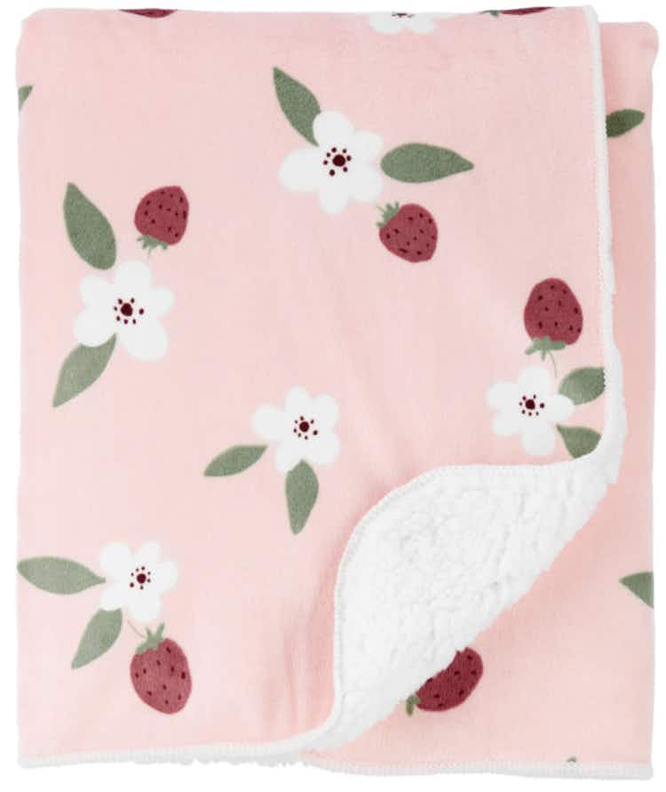a carters pink baby blanket with white flowers