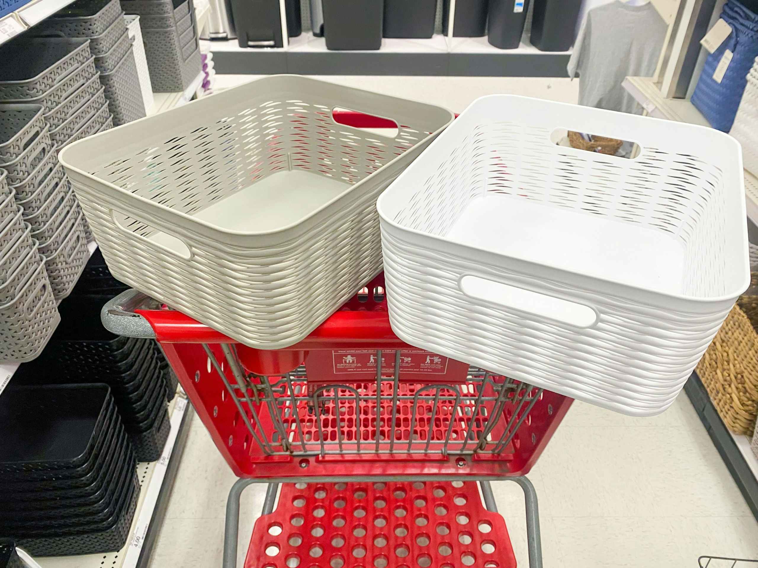 One white and one gray decorative storage basket in a Target shopping cart