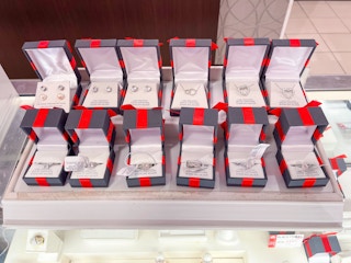 display of jewelry in red and black boxes