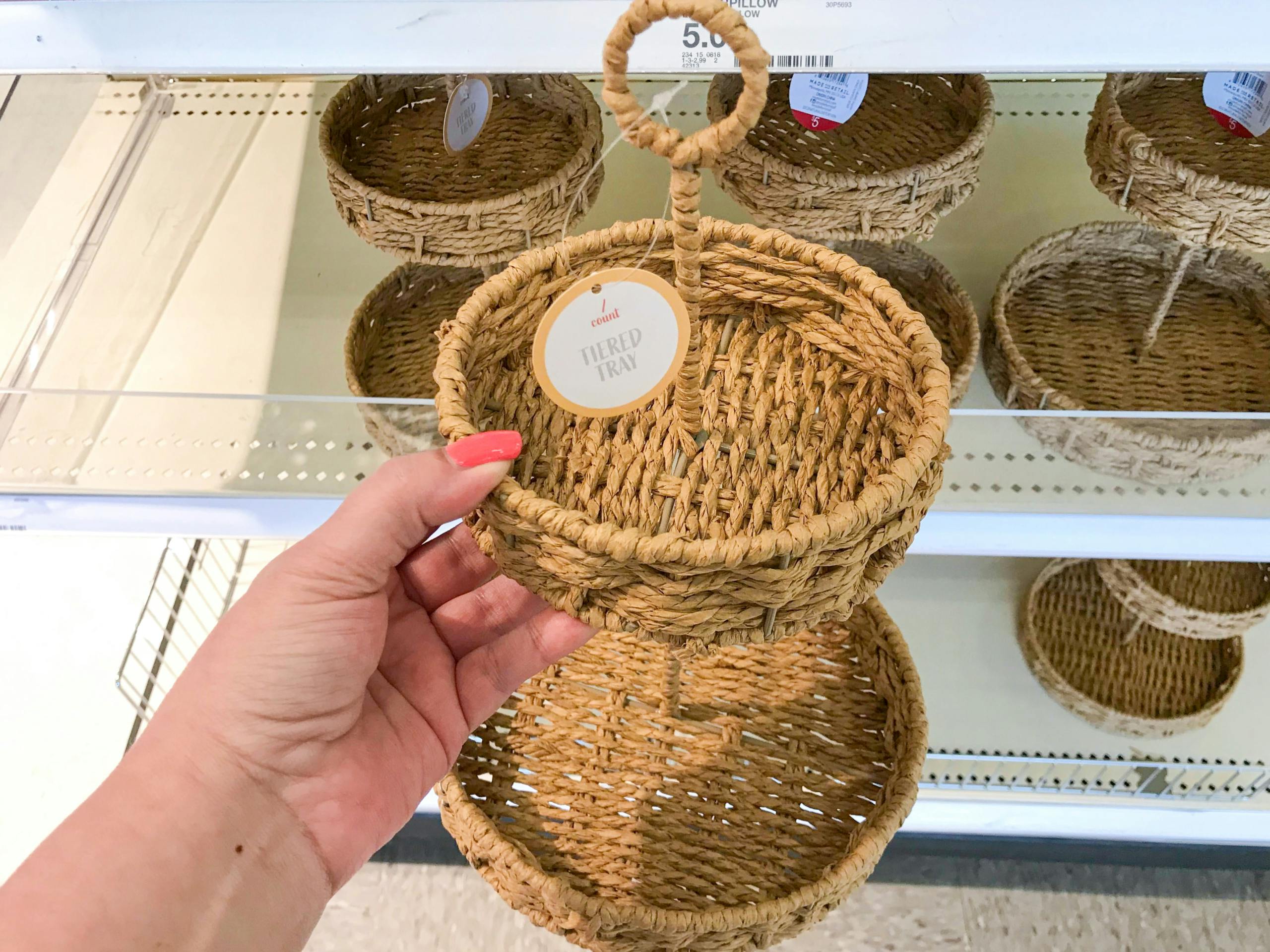 holding up rattan tray at Target