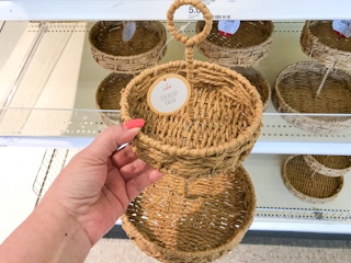 holding up rattan tray at Target