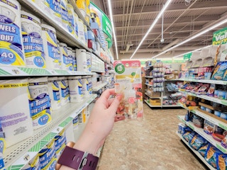 hand holding an airwick refill in an aisle