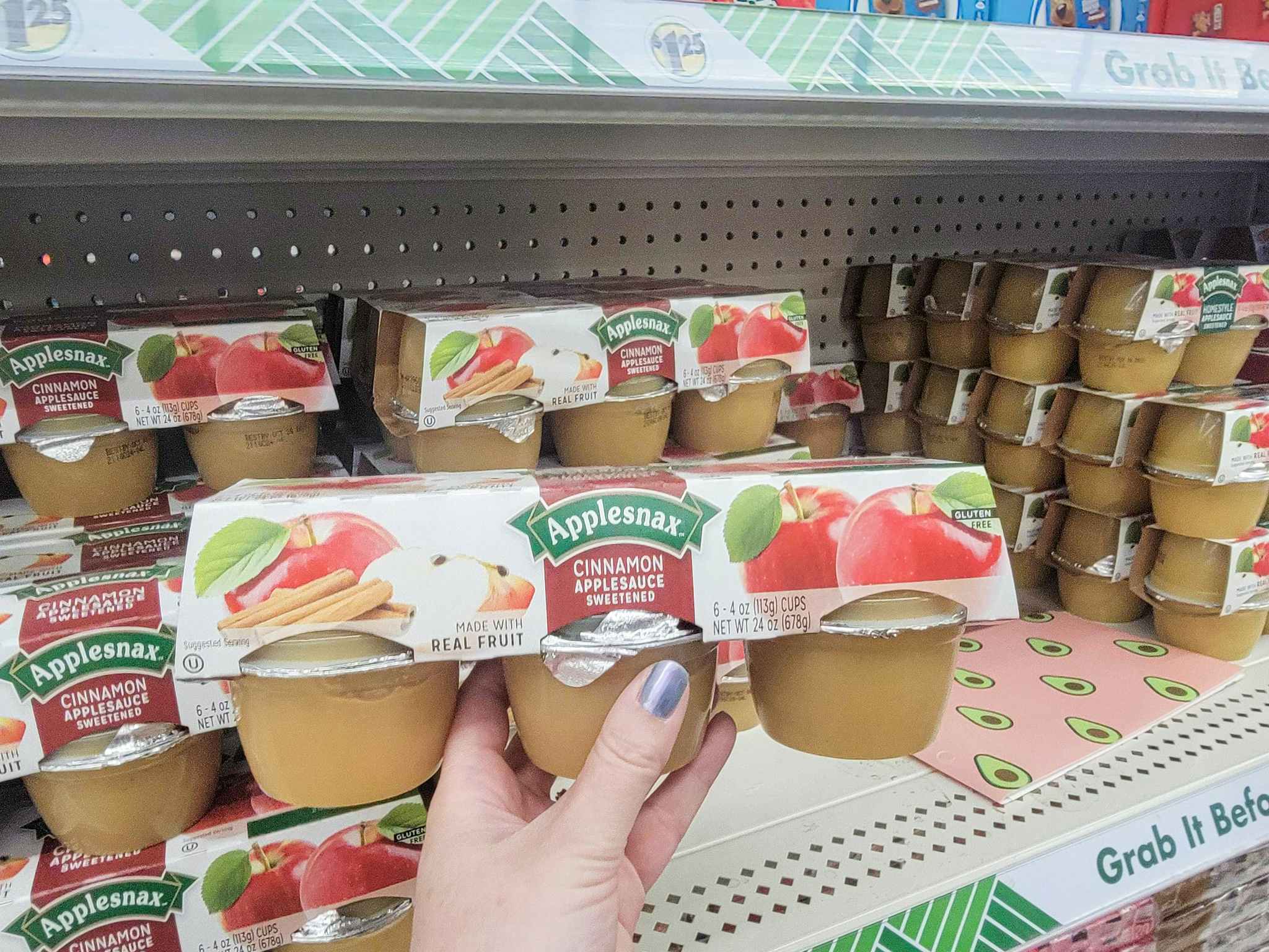 hand holding a pack of 6 applesauce cups