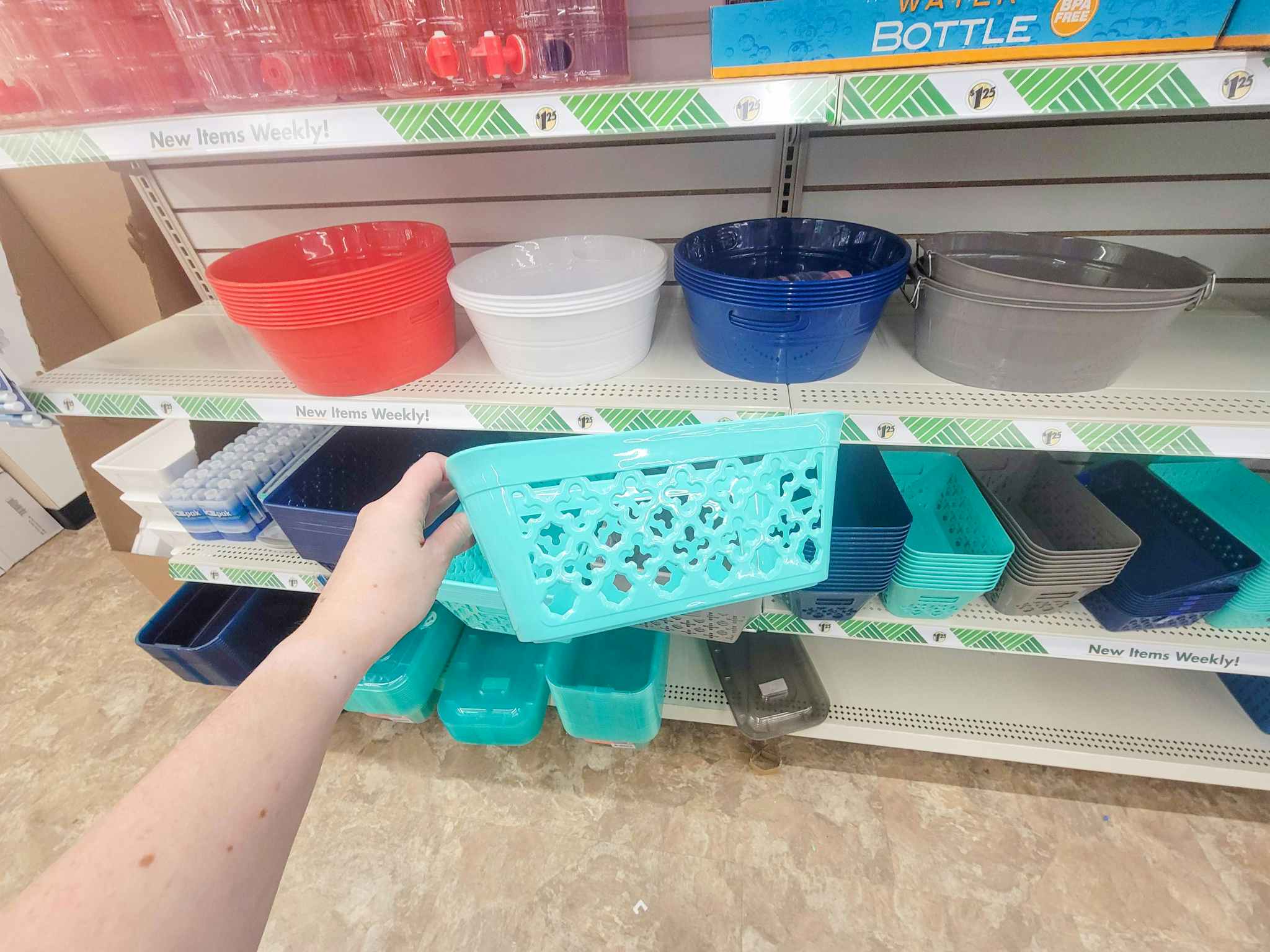 hand holding a teal storage basket