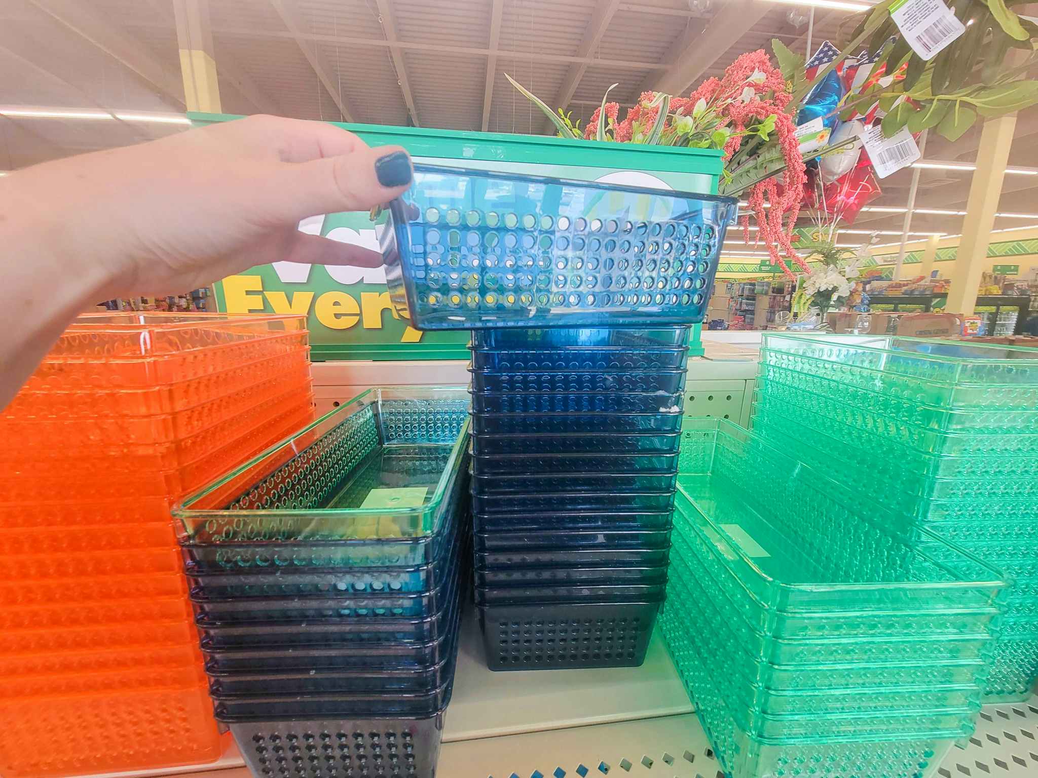 hand holding a navy blue organizing bin