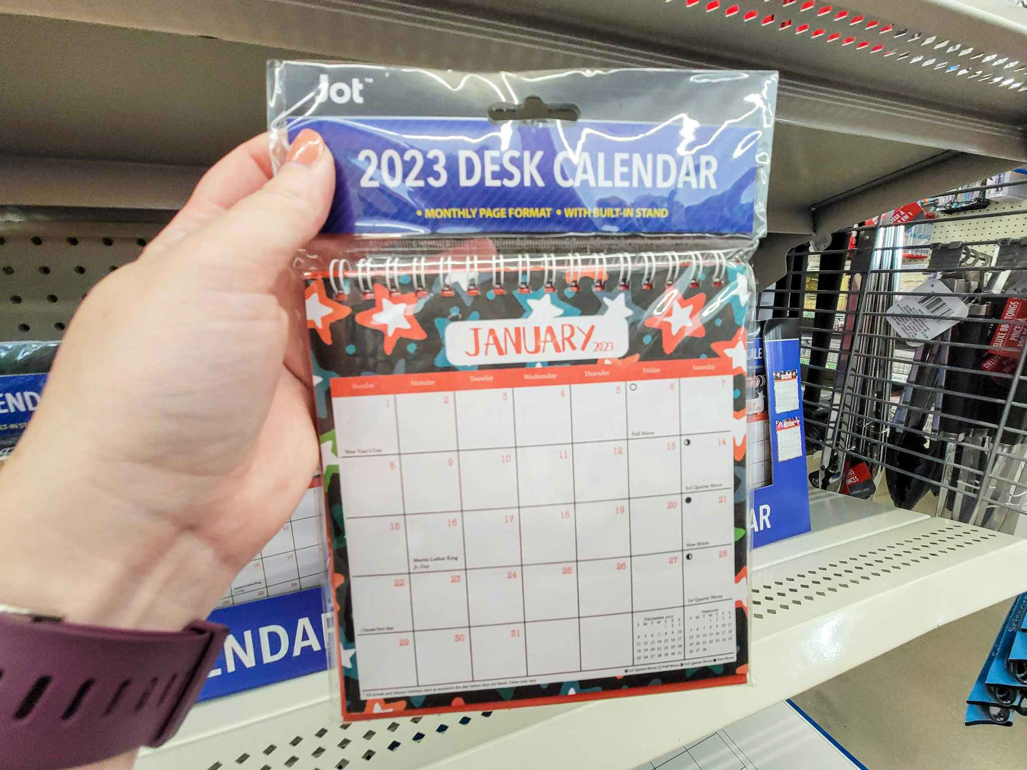 hand holding a desk calendar for 2023