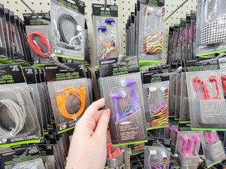 hand holding a pair of purple ear buds