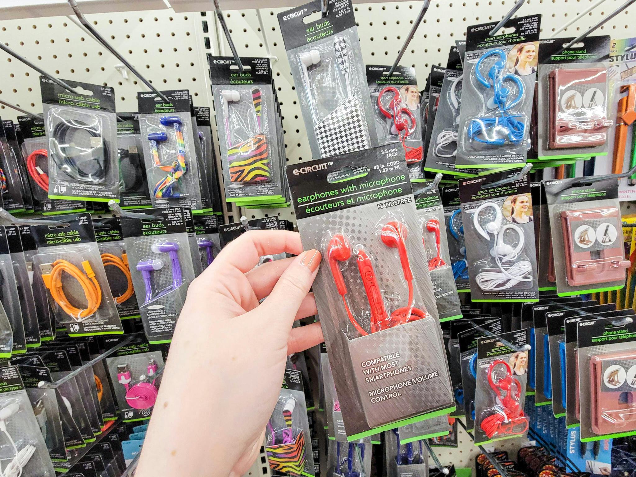 hand holding a pair of red ear buds