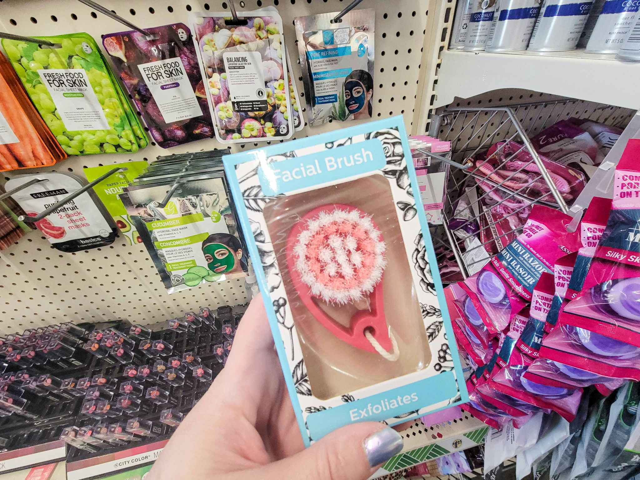 hand holding an exfoliating facial brush