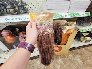 hand holding a brown crafting mesh tube