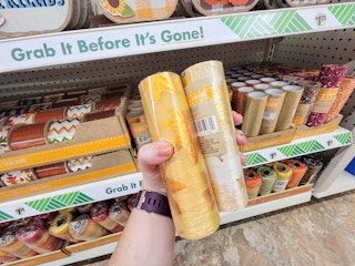 hand holding 2 tubes of mesh craft ribbon