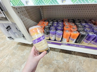 hand holding a roll of decorative halloween mesh for crafting