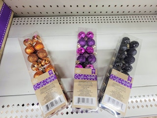 small round ornaments in orange, purple, and black