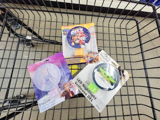 frozen, paw patrol, and mandalorian night lights in a cart