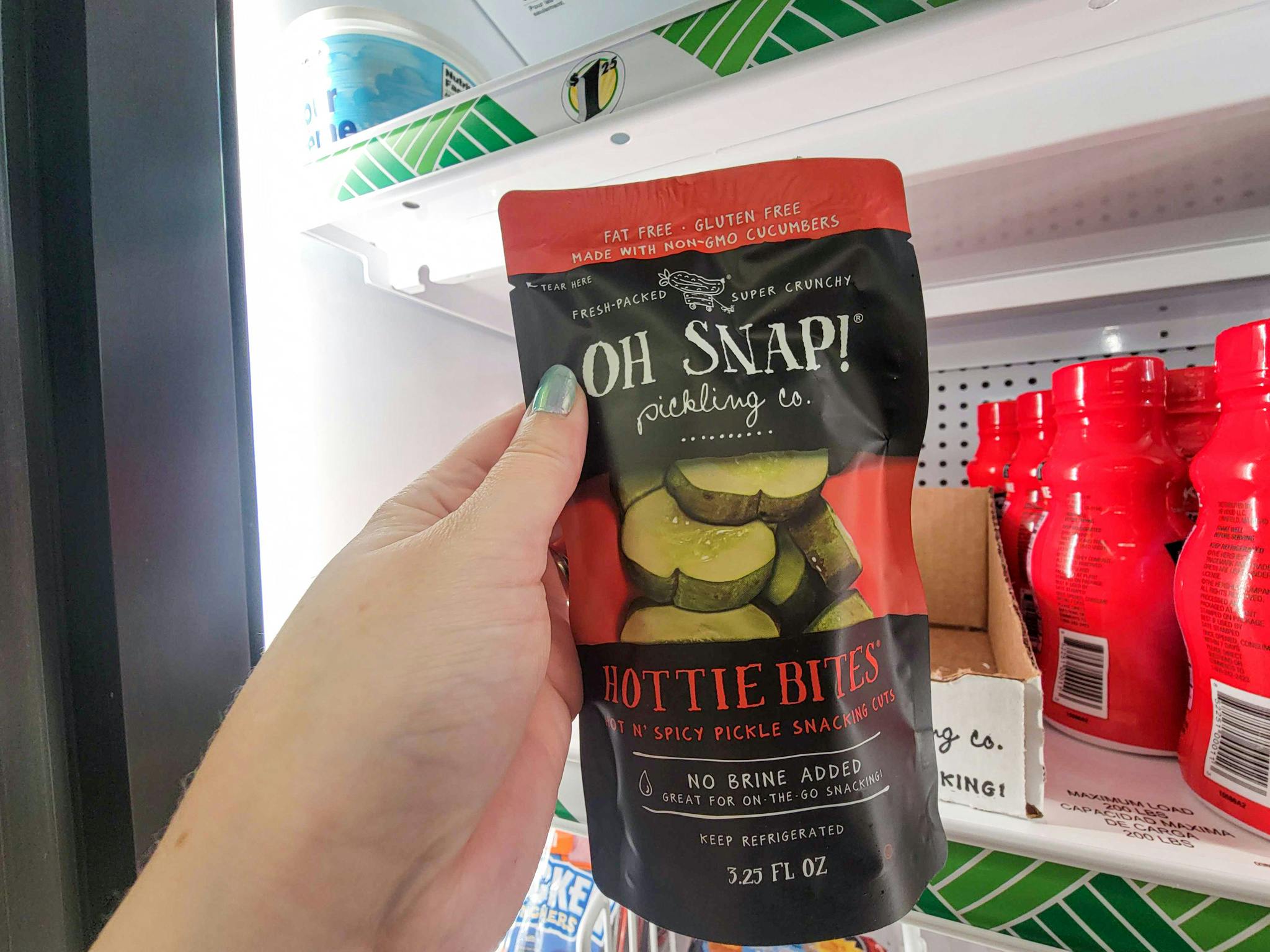 hand holding a bag of oh snap pickles