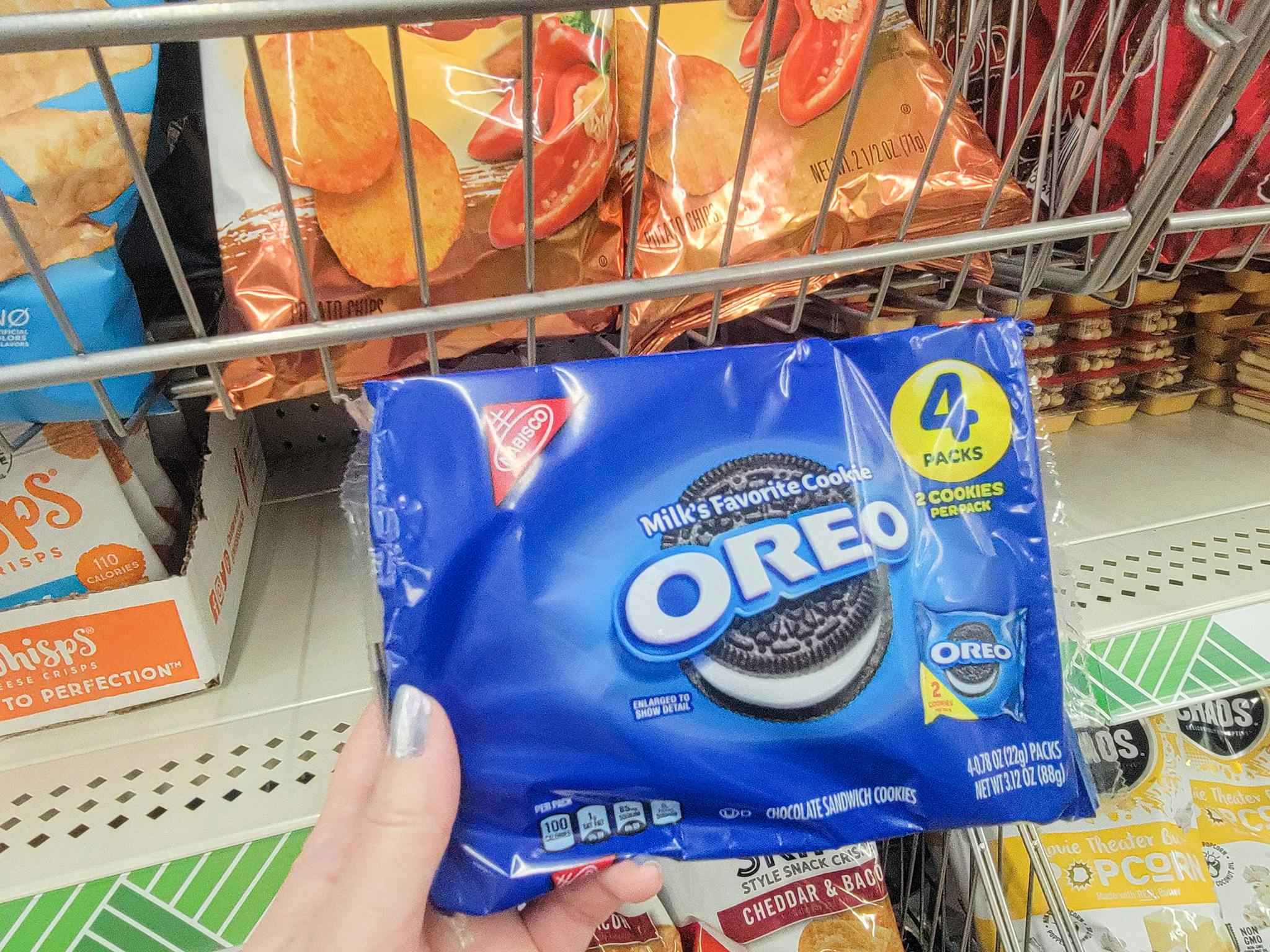 hand holding a pack of oreos