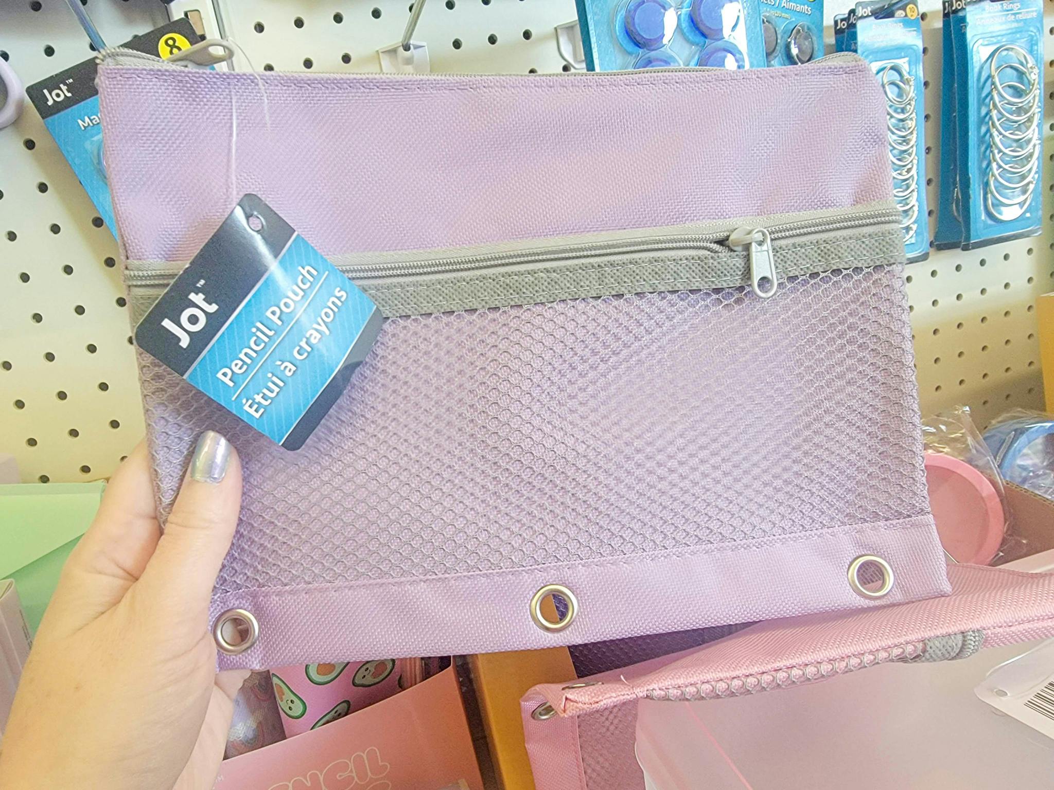 hand holding a purple pencil binder pouch