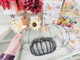 hand holding a pumpkin wreath form