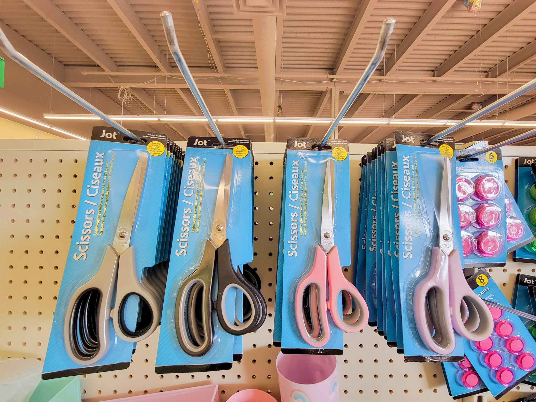 scissors in different colors hanging up