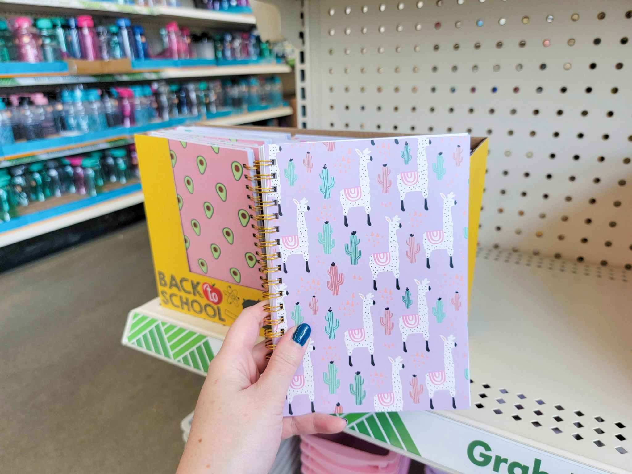 hand holding a small notebook with llamas on it